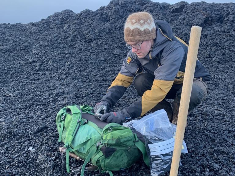 Simon Matthews collecting samples of the new lava and tephra in January 2024.